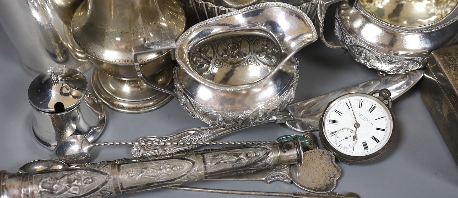 An Indian white metal cream and sugar bowl by Krishnian Chetty of Bangalore, a modern silver beaker by The Marlow Brothers, a sterling sugar caster, silver cigarette box, Chinese white metal teapot and nine other items.